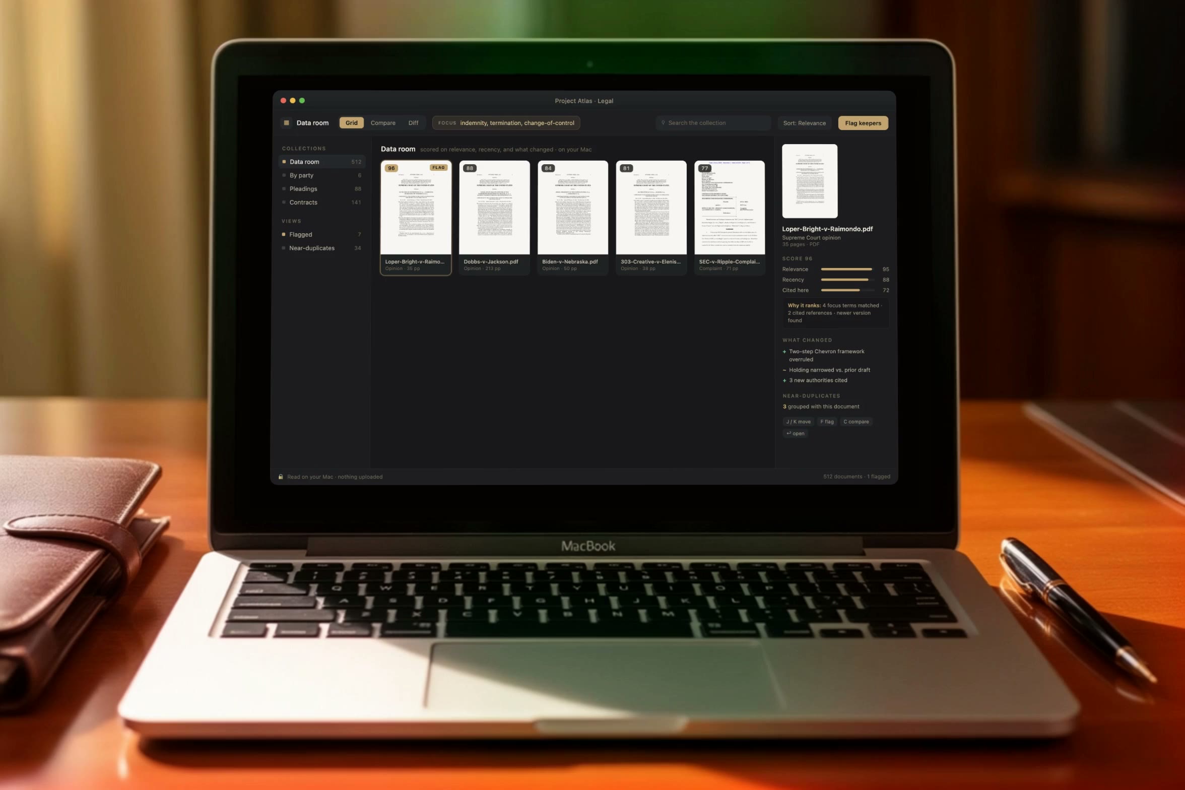 PageHawk open on a MacBook on a sunlit law-office desk, showing a 512-document legal data room: every file scored on relevance and recency, the keeper flagged, and a panel showing what changed, every line crisp.